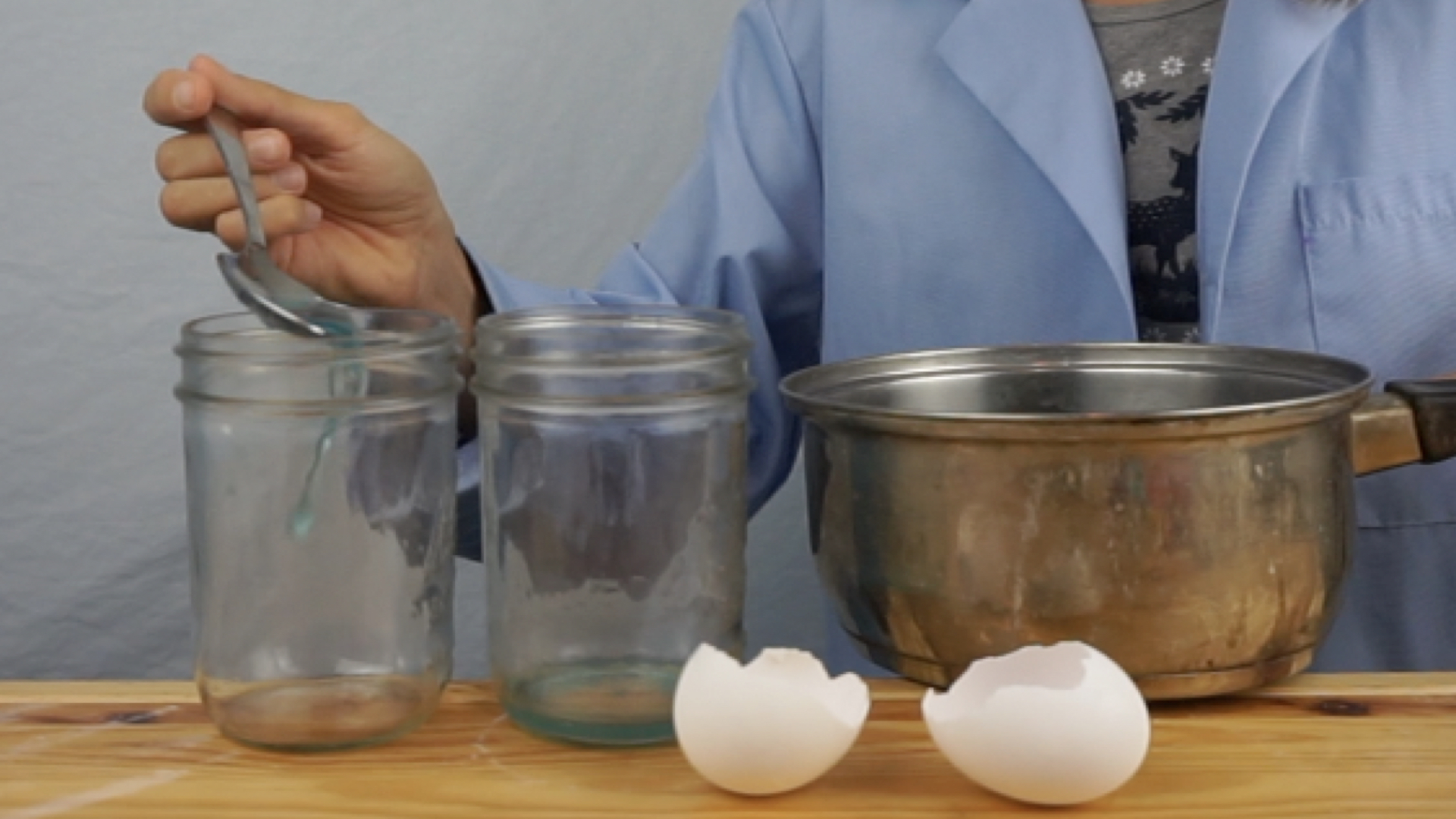 Pouring a spoonful of hot liquid into the glass first.